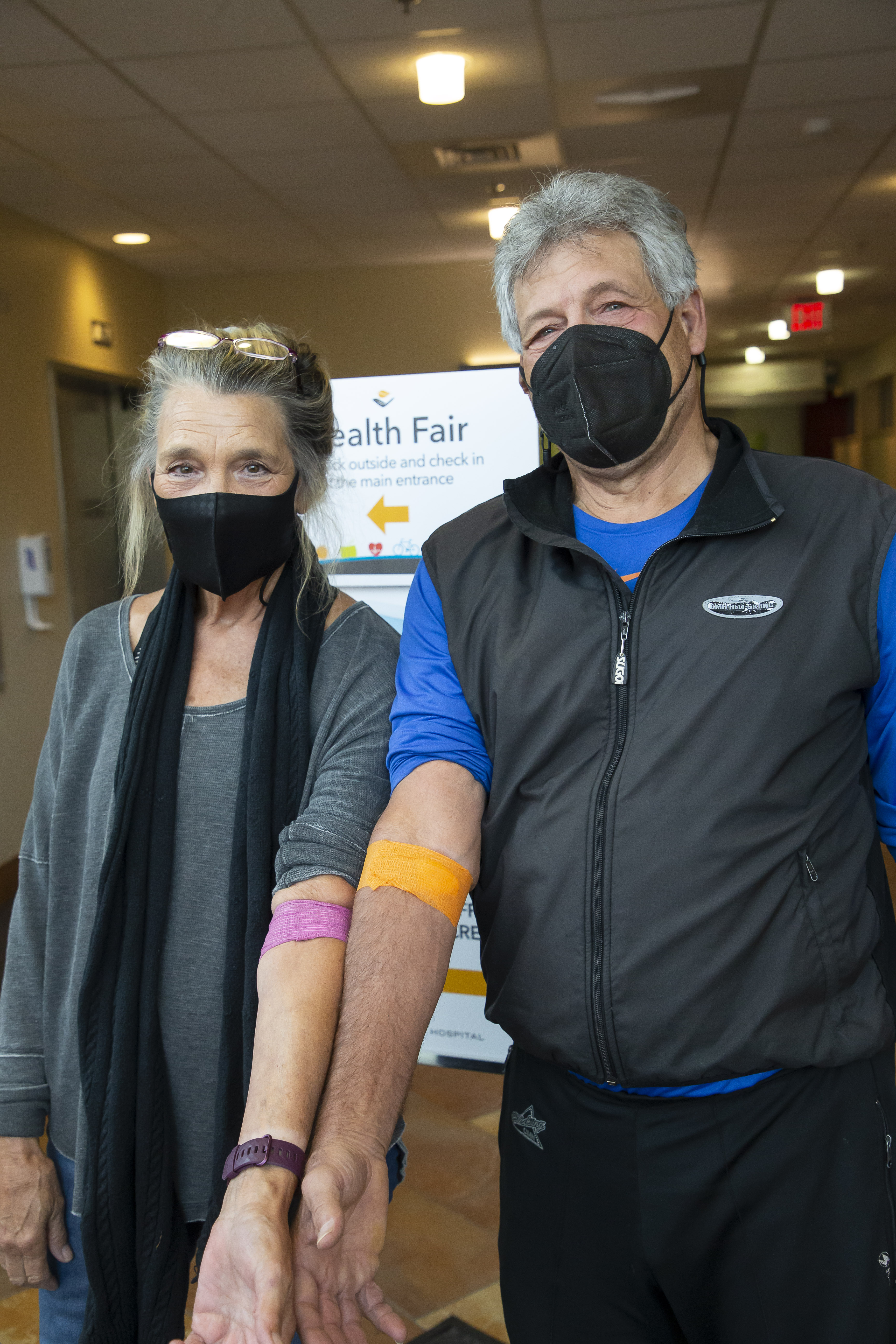 Couple showing off their blood test bandages