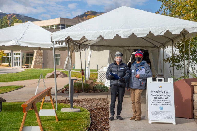 Volunteers with clipboards helping attendees