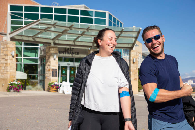 Man and woman smiling outside the health fair
