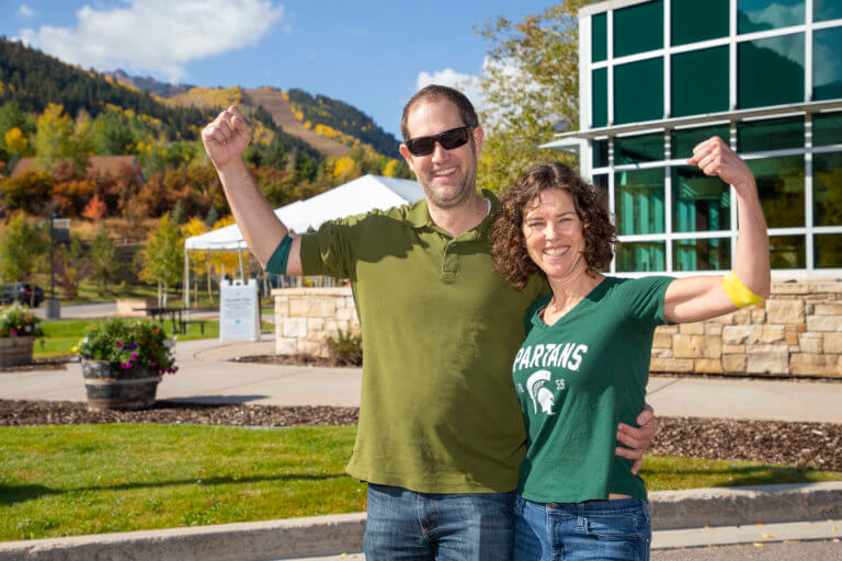 Couple flexing arms in front of the hospital