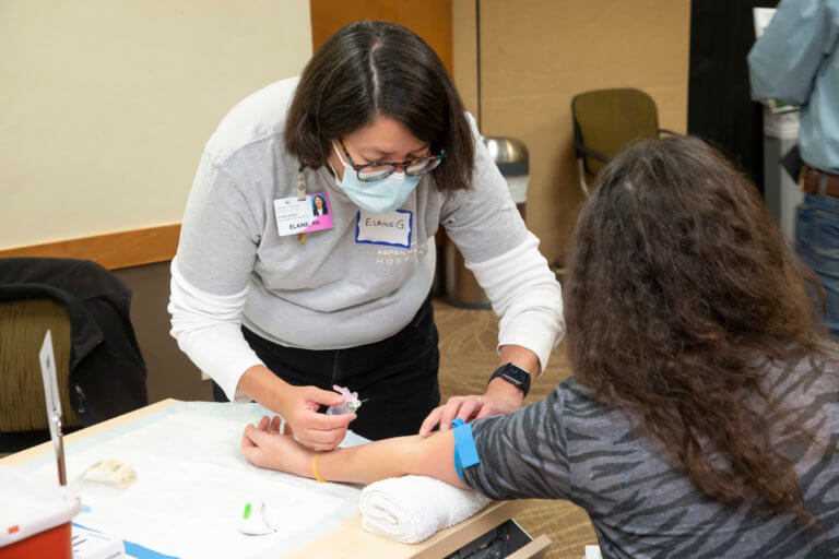 Nurse administering a blood test
