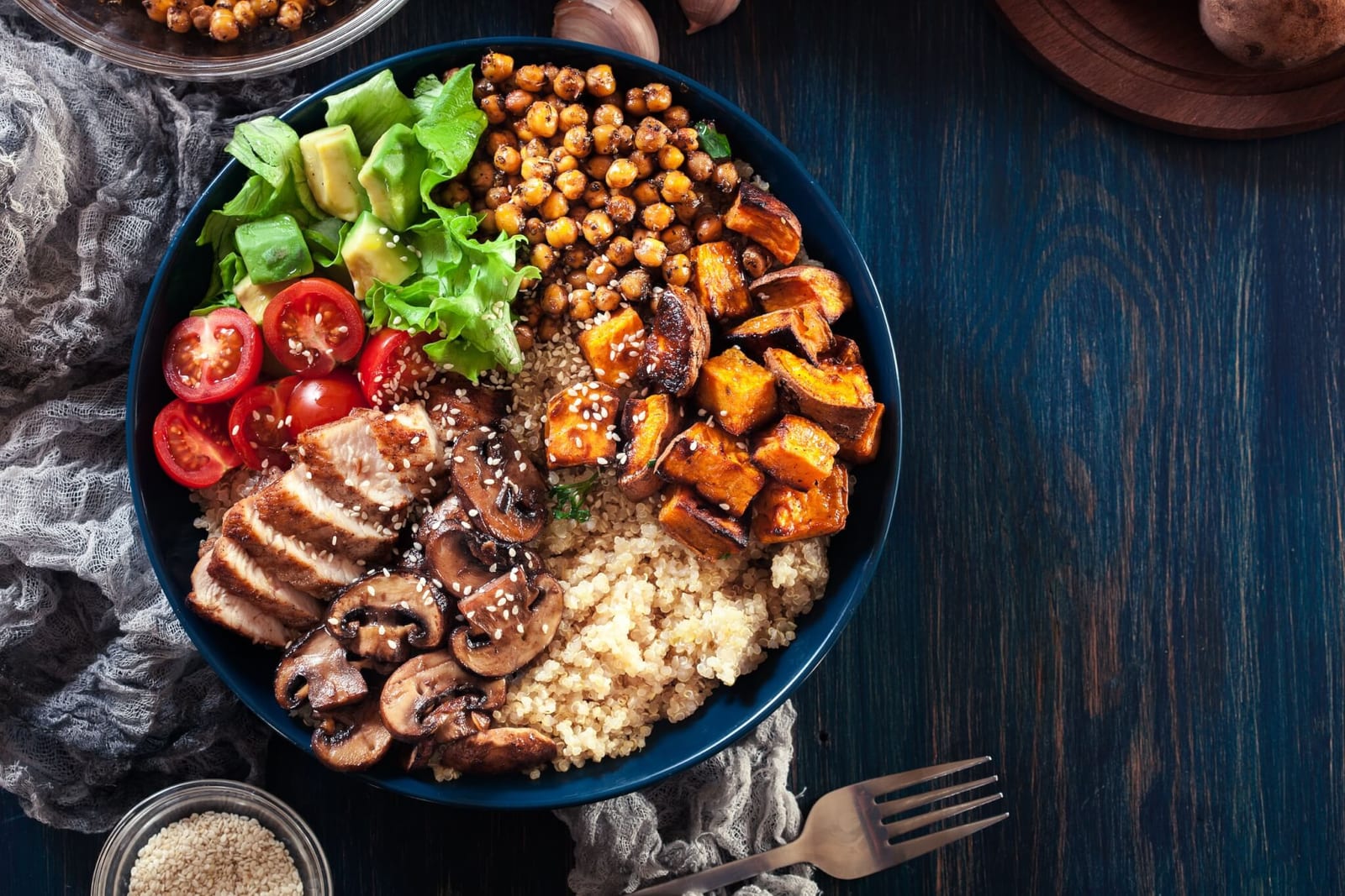high fiber bowl with chickpea, squash, mushrooms, tomato, avocado, and quinoa which are some of the best foods for colon health