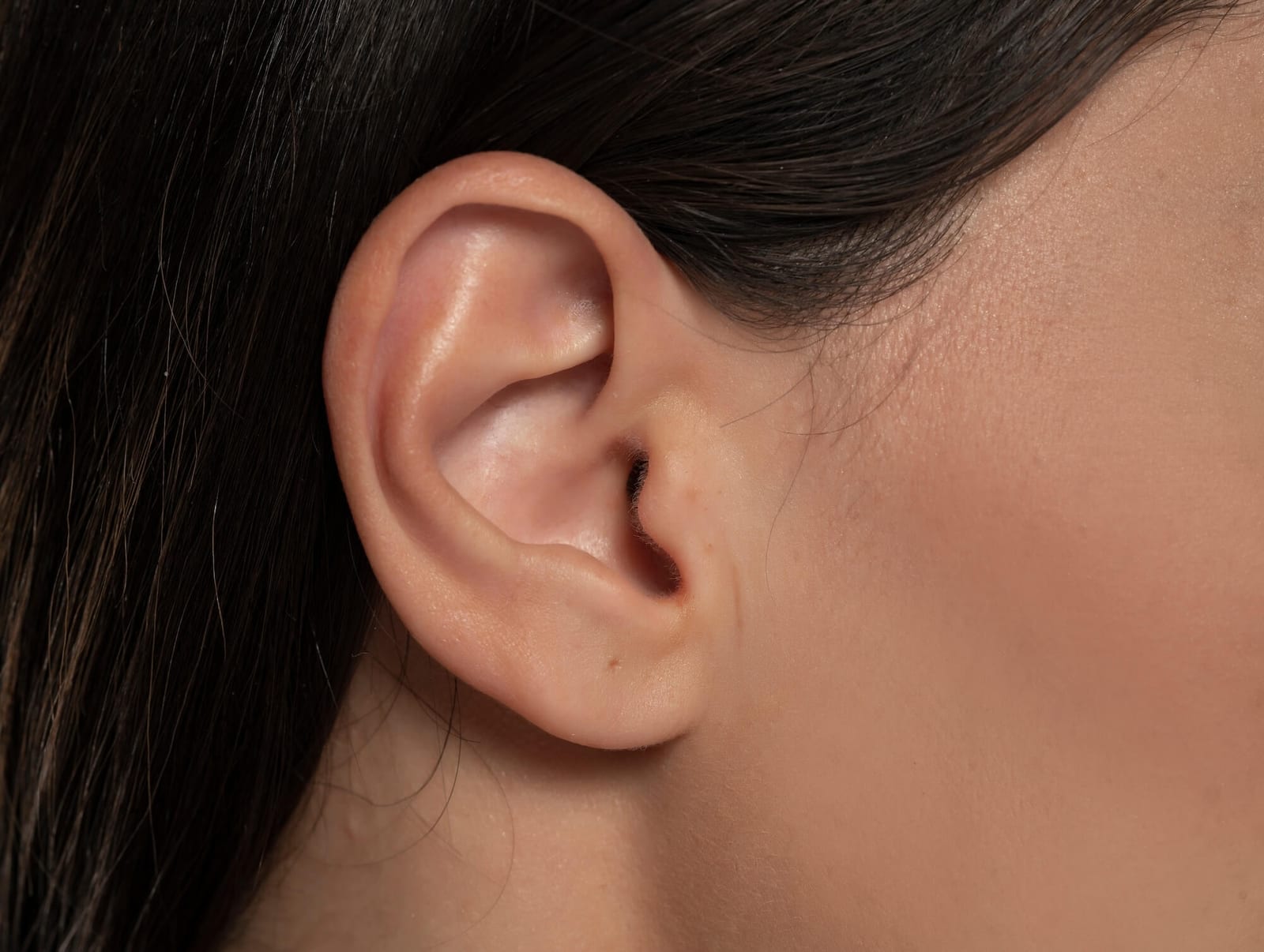 Detail of the head with female human ear and hair close up