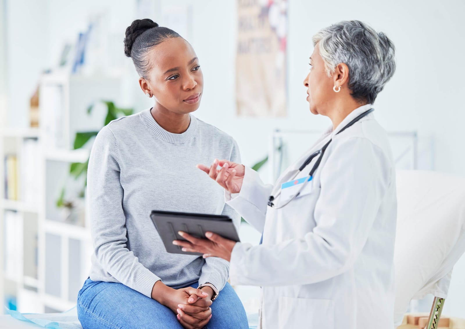 Doctor, woman and tablet for hospital, healthcare advice and support for results, exam and test on bed. Senior expert or medical people on digital tech for clinic sign up, registration and consulting.