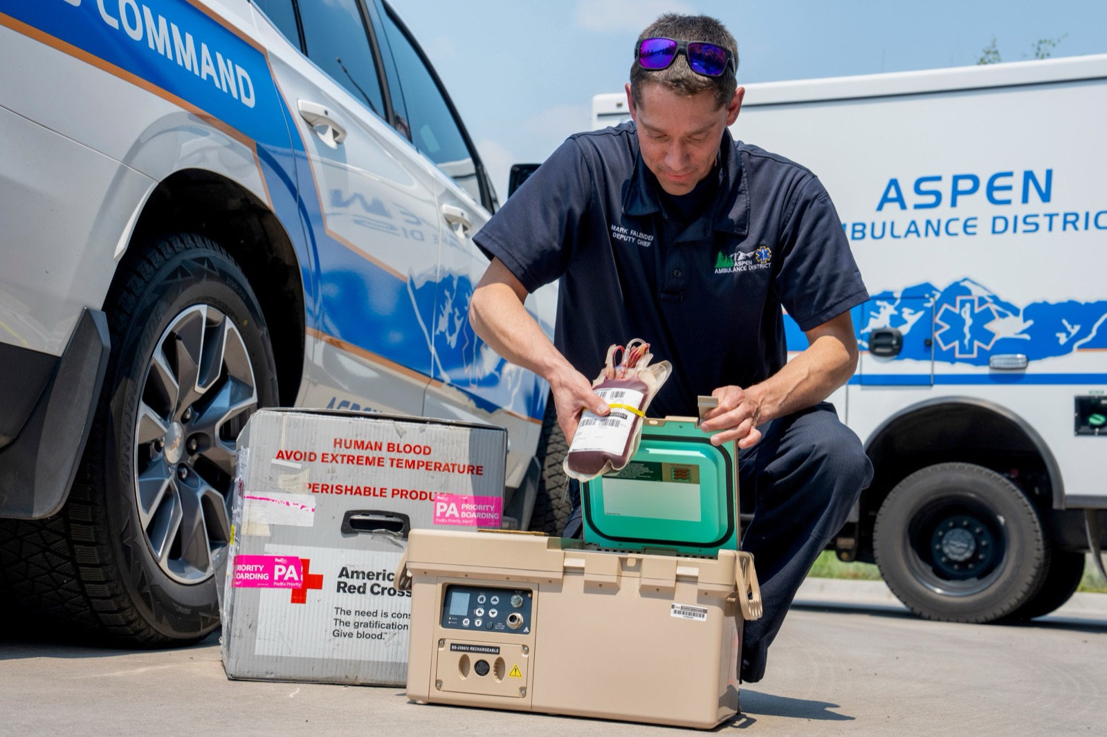 Mark Falender, Deputy Chief of EMS at Aspen Ambulance District, places blood in a temperature-controlled cooling unit.