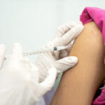 Patient receiving injection in her arm
