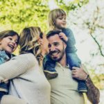 Young family outdoors smiling