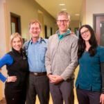 staff posing for photo with patient