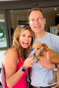 couple posing with dog