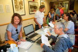 attendees completing documents at event