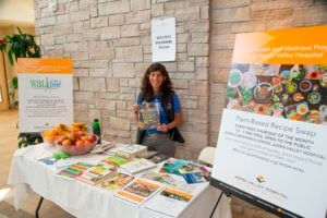 staff member at booth for recipe books