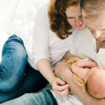 New parents holding newborn baby