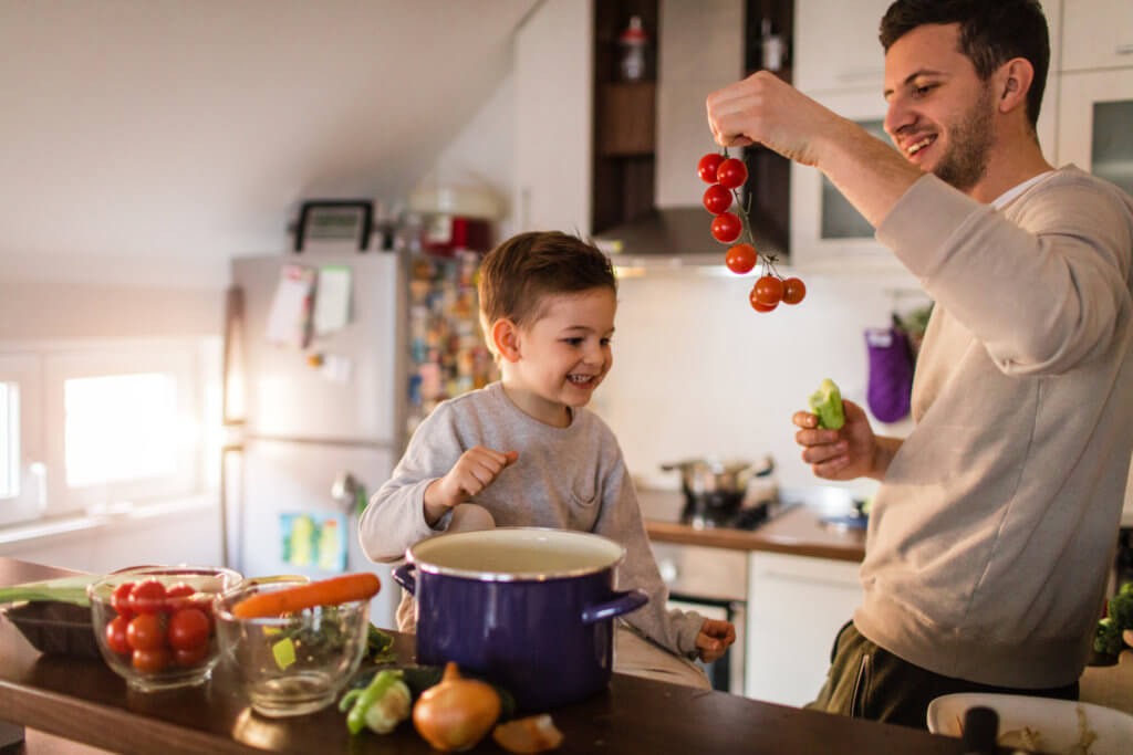father and son making soup