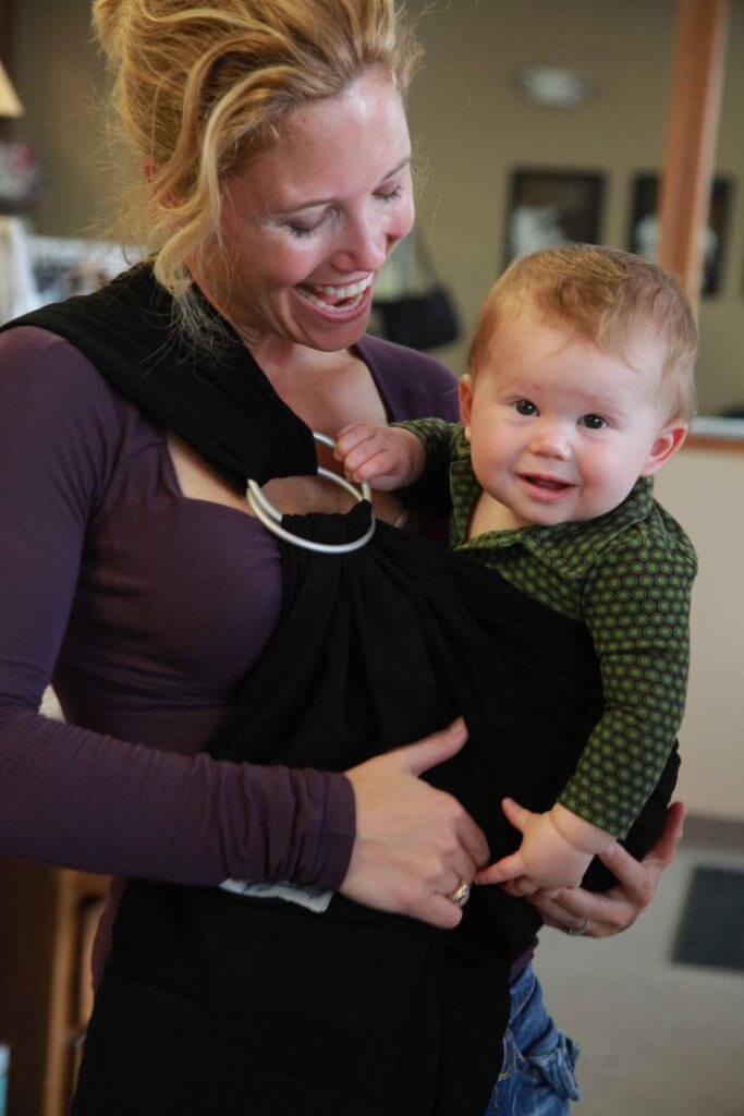 mother holding baby in bjorn