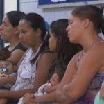 Mothers sitting tired in line