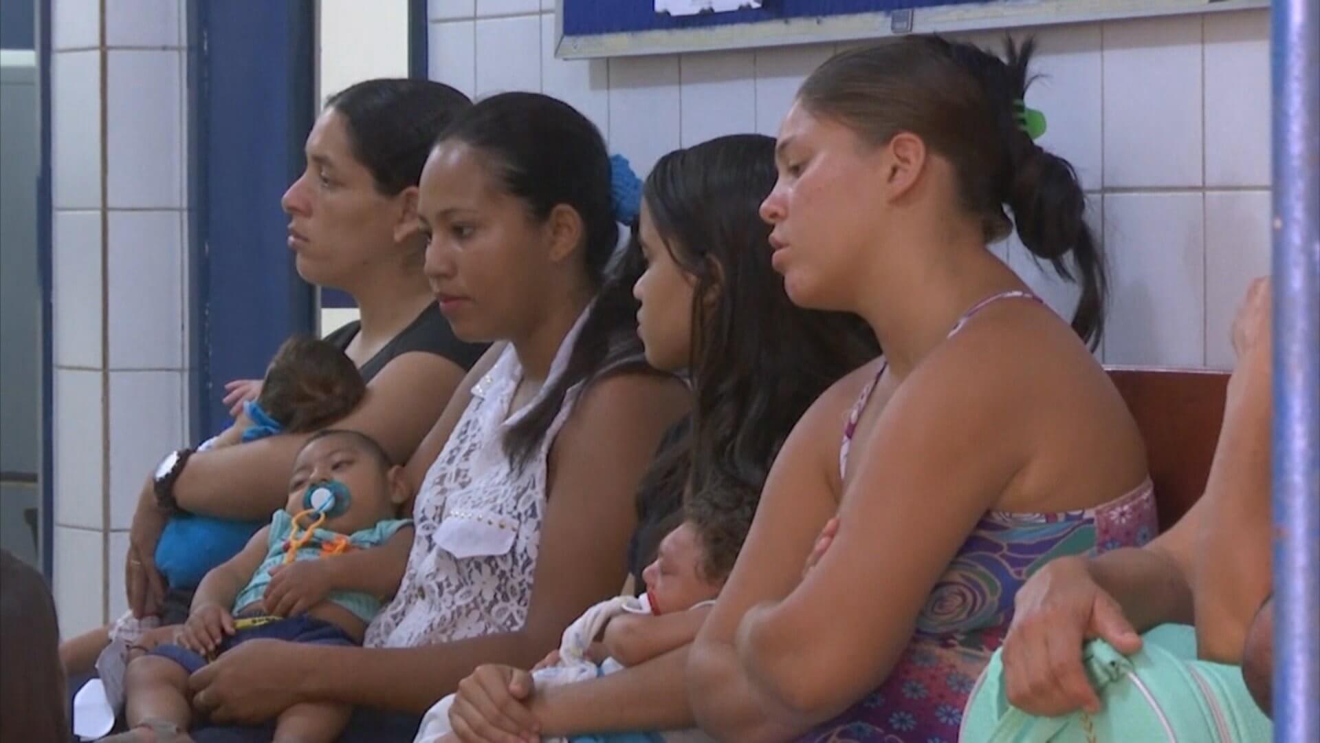 Mothers sitting tired in line