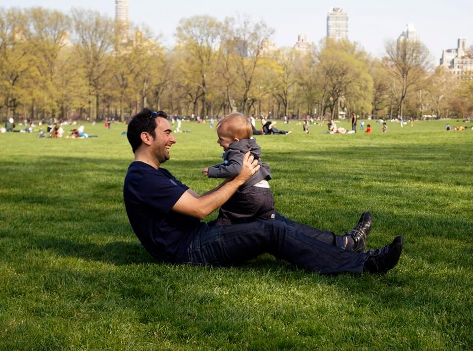 Man holding baby in the park
