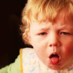 young child coughing