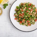 Tabbouleh salad with bulgur, fresh herbs, vegetables and salad dressing Healthy Recipes with Summer Produce
