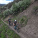 bikers on trail on side of mountain