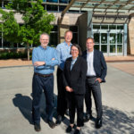 business people smiling outside of building