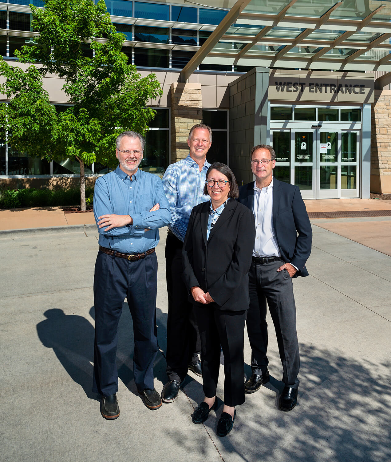 business people smiling outside of building