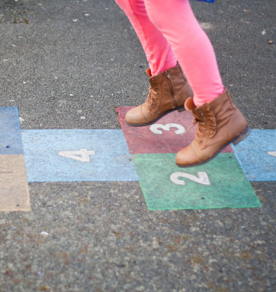 girl playing hop scotch