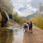 Hikers by waterfall