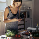 woman looking at recipe on phone