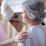 middle aged woman receiving mammogram