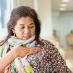 Senior woman hand holding at breast for check up