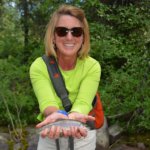 happy woman holding fish