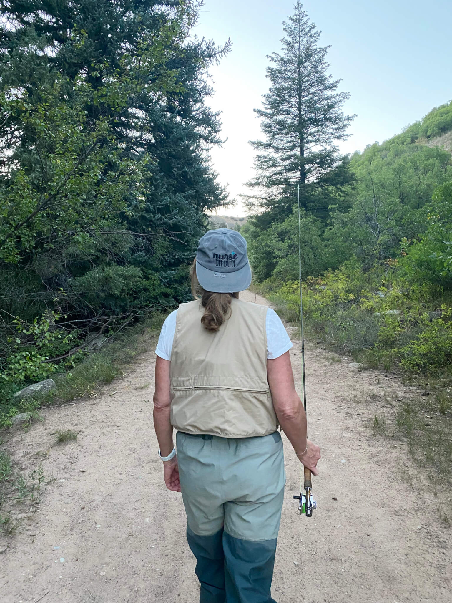 Nurse off duty going walking with fishing rod