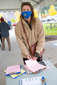 woman at registration smiling outside