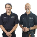 two men in working uniforms