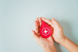 red blood shape in woman's hands