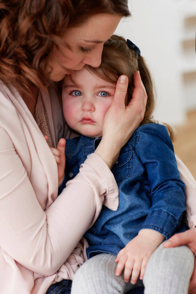 Young mother comforting her little daughter what to know about rsv flu covid featured image