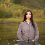 Woman standing waist deep in still waters