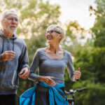 Smiling senior couple jogging in the park - how to prevent sarcopenia