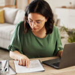 Woman with laptop in home office