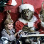 Cindy Lou and the Grinch with a large bundle of presents behind them