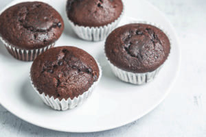 bakery chocolate cupcakes in a dish on a white background Tasty Wintertime Eats (and Treats)