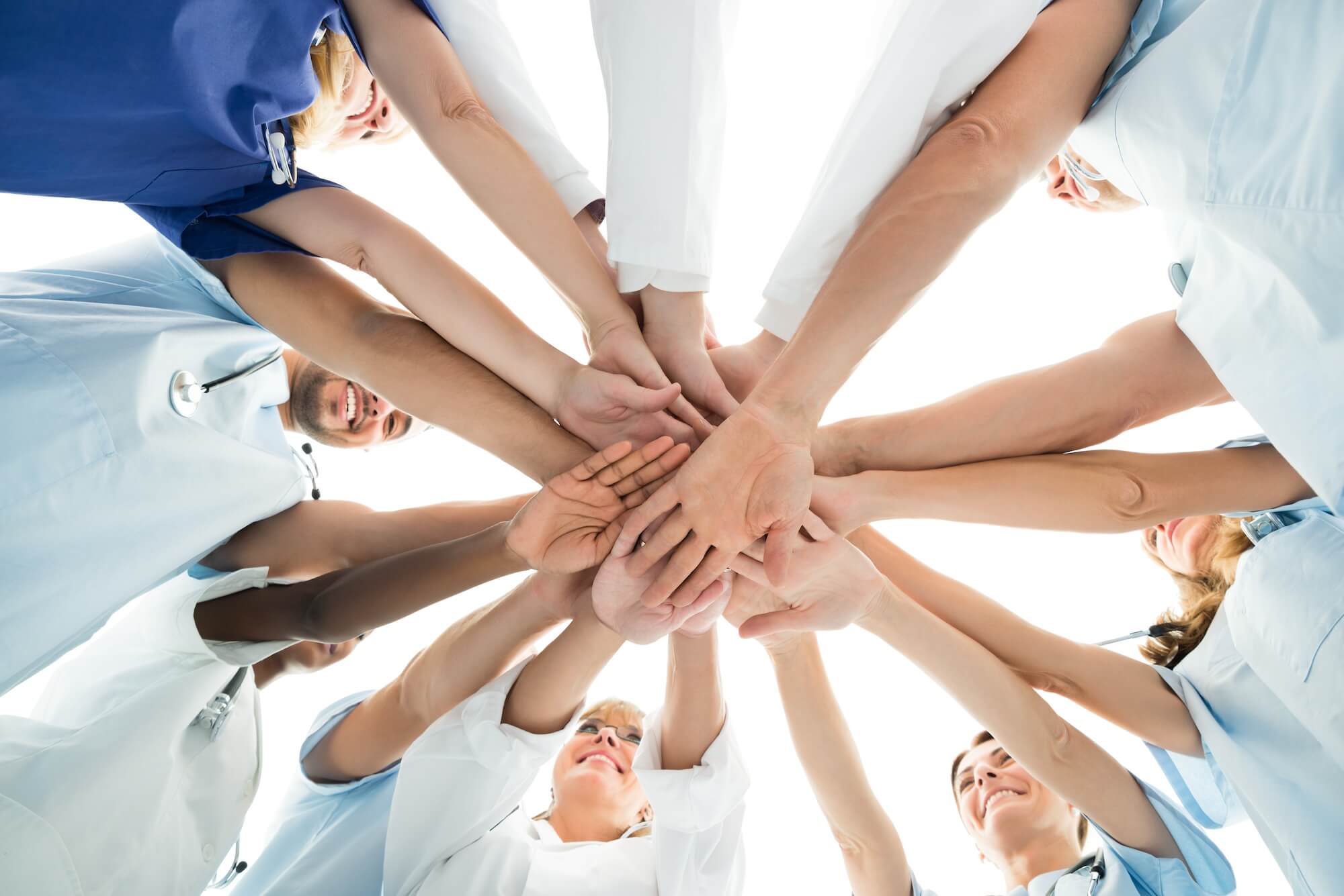 group of team members' hands stacking together in the middle