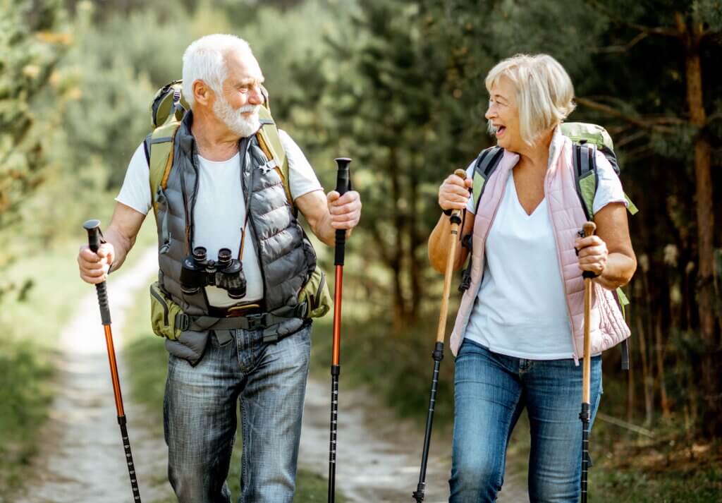 senior couple hiking in forest
