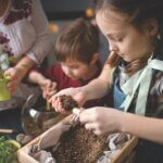 Family transplanting plants in terrarium at home