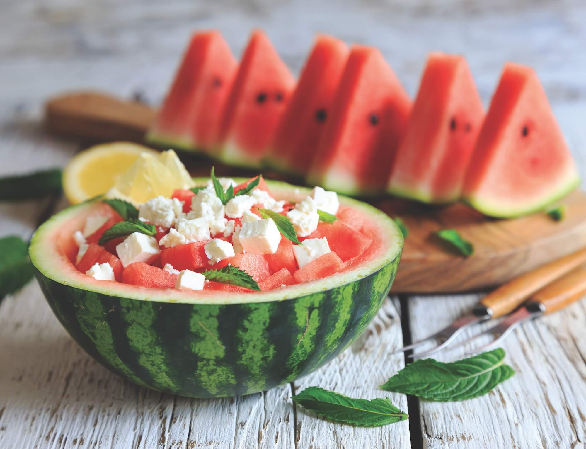 watermelon salad with feta served in watermelon healthy summer recipes featured image