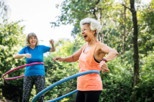 Senior woman exercising with a hula hoop mental health while aging