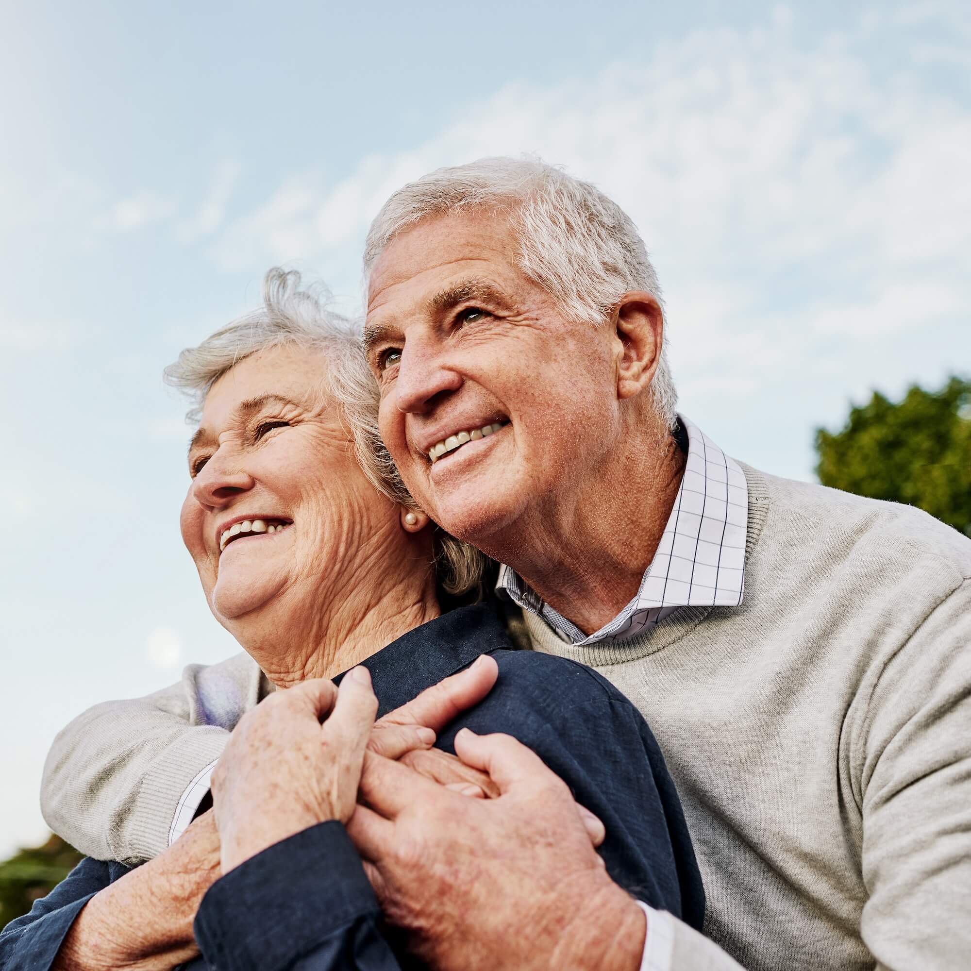 Mature, man and woman embrace at the park aging mental health