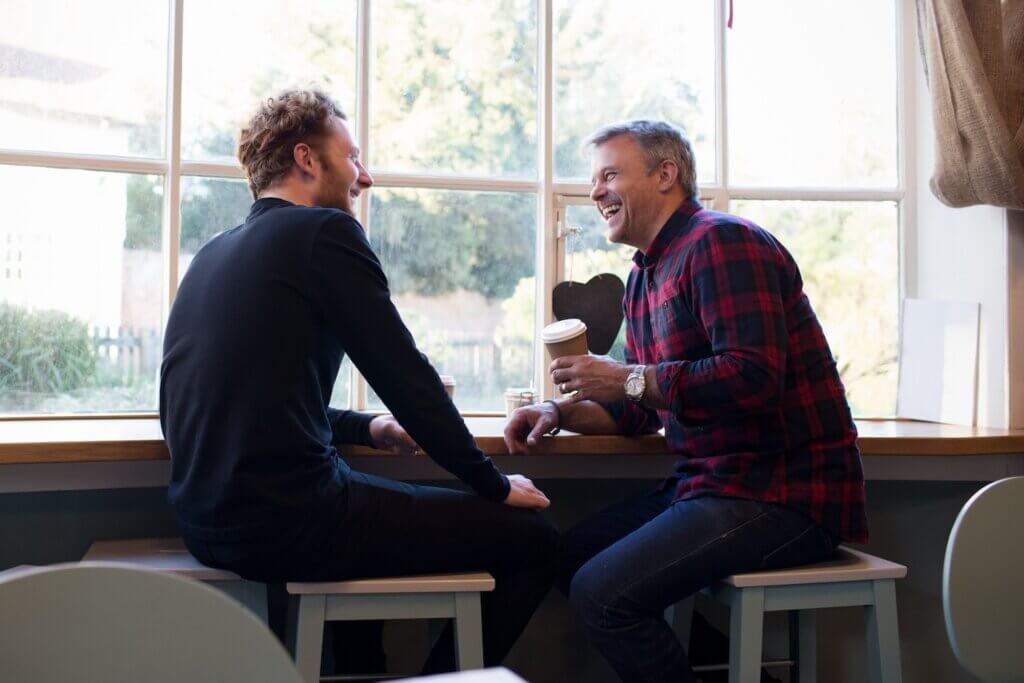 two men getting coffee and talking