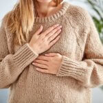 Young woman with heart problem holding chest. what is pots featured image
